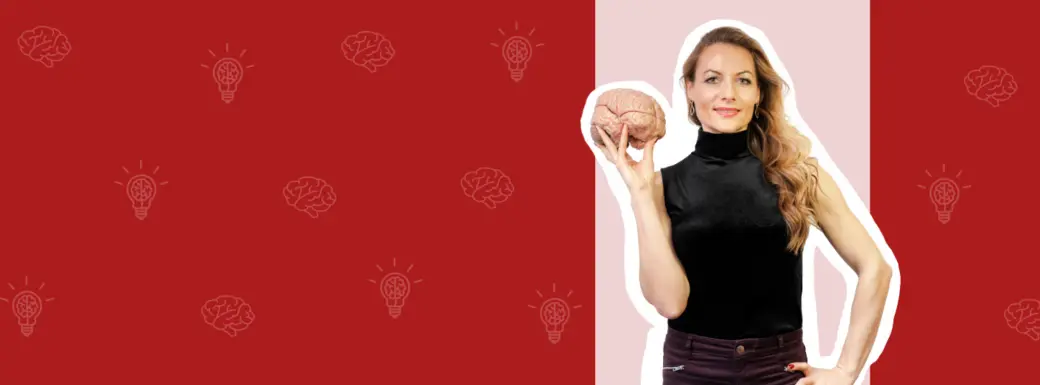 A woman with long hair is holding a brain model in one hand while standing against a red and light pink background. Lightbulb icons are faintly visible in the background, symbolizing ideas or knowledge.